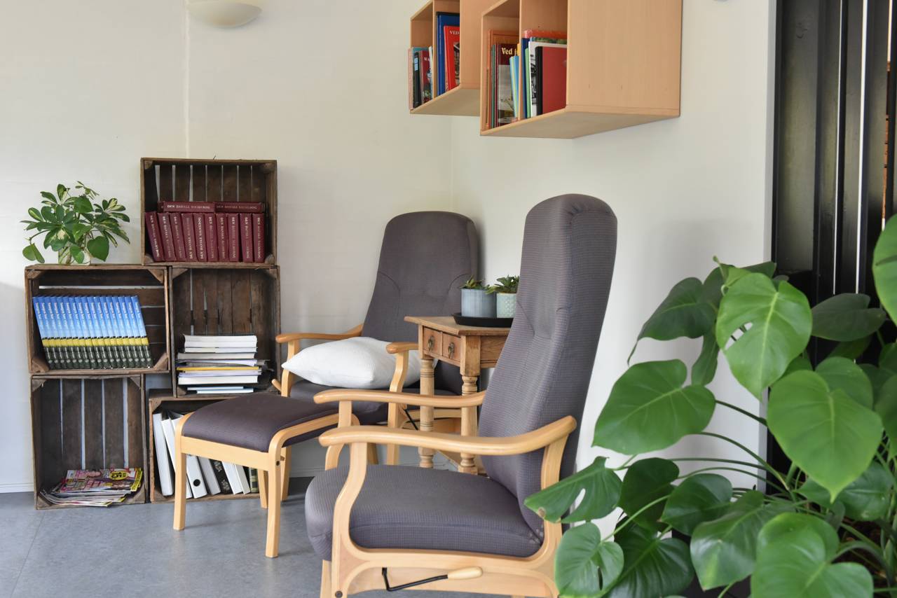 Hyggekrog med lænestole og bogreol hos Kristrupcentret